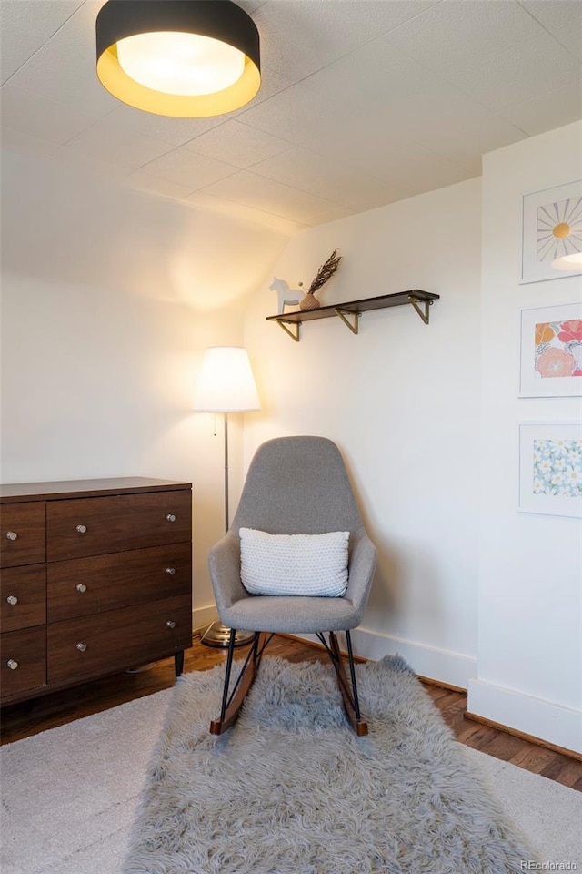 living area featuring wood finished floors and baseboards