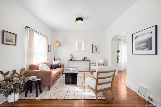 5103 Quitman St, Denver, CO 80212 - living room featuring arched walkways, plenty of natural light, and wood finished floors