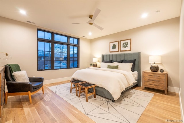 bedroom with light wood-style floors, visible vents, and baseboards