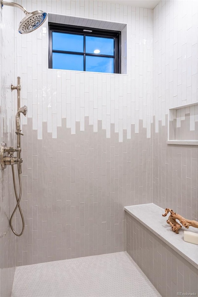 bathroom with a tile shower