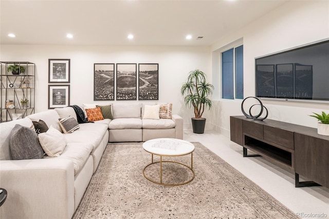 living area featuring recessed lighting and carpet