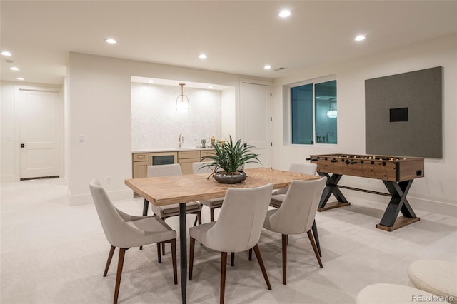 dining area featuring recessed lighting, light carpet, and baseboards