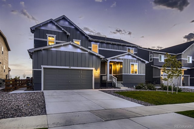38 Morgan Cir, Erie, CO 80516 - view of front of home with board and batten siding, a garage, driveway, and a lawn