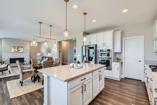 38 Morgan Cir, Erie, CO 80516 - kitchen with stainless steel appliances, open floor plan, dark wood-type flooring, and recessed lighting