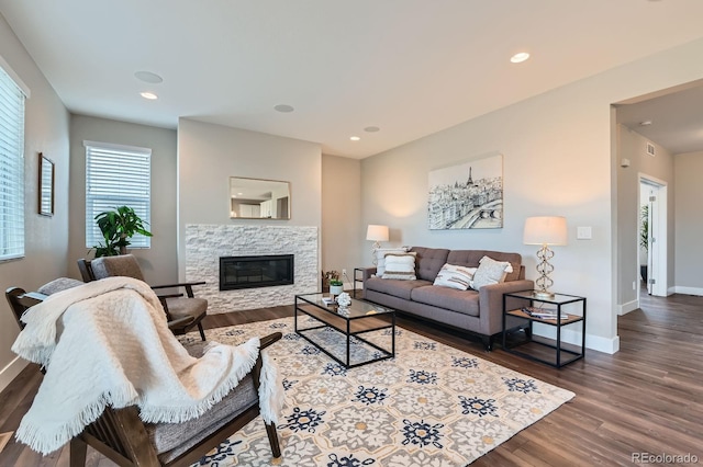 38 Morgan Cir, Erie, CO 80516 - living area with a fireplace, dark wood-type flooring, baseboards, and recessed lighting