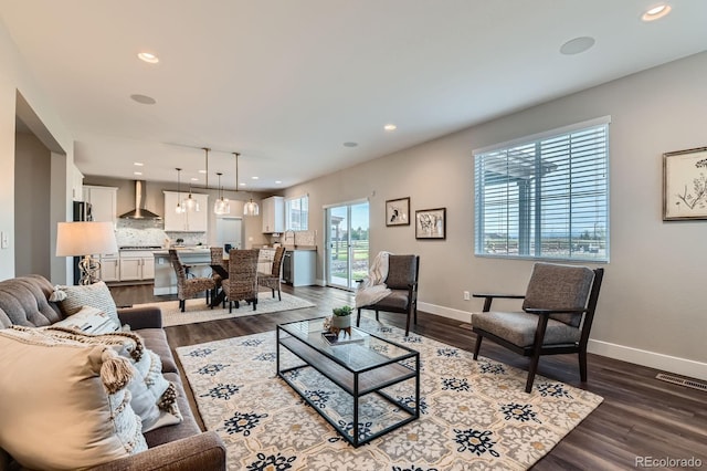 38 Morgan Cir, Erie, CO 80516 - living area featuring dark wood finished floors, recessed lighting, and baseboards