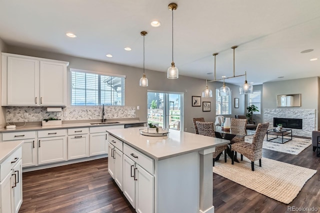 38 Morgan Cir, Erie, CO 80516 - kitchen featuring a sink, backsplash, dark wood-type flooring, white cabinets, and recessed lighting