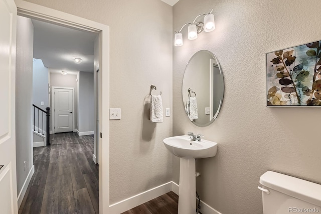 38 Morgan Cir, Erie, CO 80516 - bathroom with wood finished floors, toilet, baseboards, and a sink