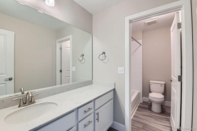 38 Morgan Cir, Erie, CO 80516 - full bathroom featuring vanity, toilet, wood finished floors, shower / bathtub combination, and baseboards