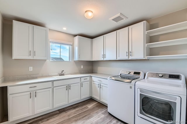 38 Morgan Cir, Erie, CO 80516 - laundry area featuring washing machine and dryer, cabinet space, light wood-type flooring, and recessed lighting