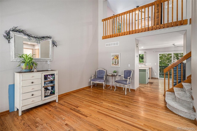 9640 Moss Rose Cir, Highlands Ranch, CO 80129 - living area with wood finished floors, stairway, and a high ceiling