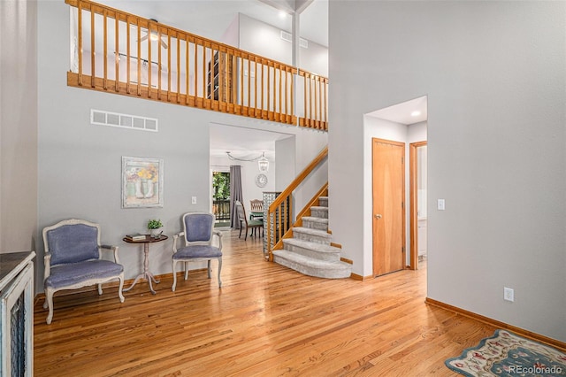 9640 Moss Rose Cir, Highlands Ranch, CO 80129 - foyer entrance with stairs, wood finished floors, and a towering ceiling