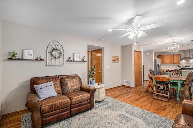 9640 Moss Rose Cir, Highlands Ranch, CO 80129 - living area with a ceiling fan, light wood-style flooring, a chandelier, and recessed lighting
