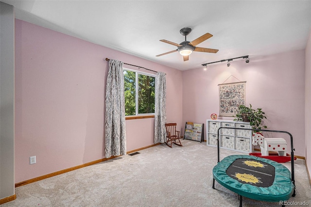 9640 Moss Rose Cir, Highlands Ranch, CO 80129 - playroom featuring rail lighting, carpet floors, and a ceiling fan