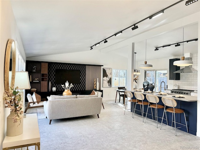 living room featuring lofted ceiling and track lighting