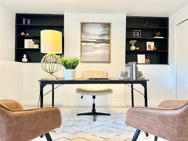 home office featuring built in shelves