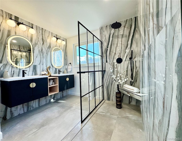 bathroom featuring vanity, a tile shower, and concrete floors