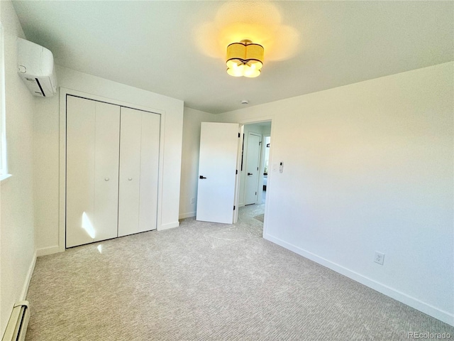 unfurnished bedroom featuring a baseboard heating unit, light colored carpet, a wall unit AC, and a closet