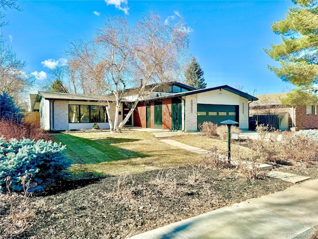 ranch-style house featuring a garage and a front lawn