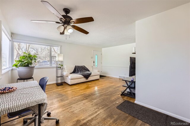 office space featuring hardwood / wood-style floors, a textured ceiling, and ceiling fan