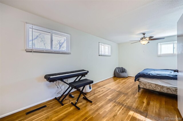 bedroom with ceiling fan and wood-type flooring