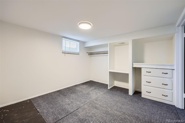 spacious closet with dark carpet