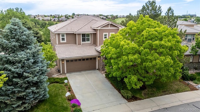 3126 Aspen Creek Dr, Highlands Ranch, CO 80129 - view of front of property with a garage, driveway, stone siding, and a tiled roof