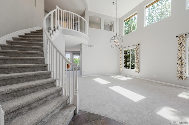 3126 Aspen Creek Dr, Highlands Ranch, CO 80129 - stairs with a high ceiling, baseboards, carpet flooring, and a chandelier