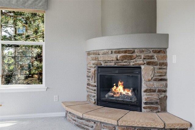 3126 Aspen Creek Dr, Highlands Ranch, CO 80129 - detailed view of a stone fireplace, baseboards, and carpet floors
