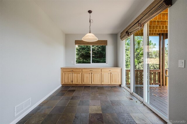 3126 Aspen Creek Dr, Highlands Ranch, CO 80129 - unfurnished dining area featuring stone tile floors and baseboards