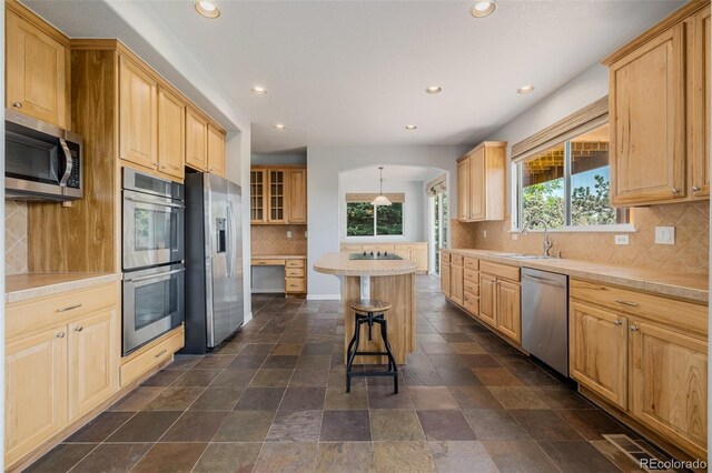 3126 Aspen Creek Dr, Highlands Ranch, CO 80129 - kitchen featuring stainless steel appliances, recessed lighting, tasteful backsplash, a breakfast bar area, and plenty of natural light