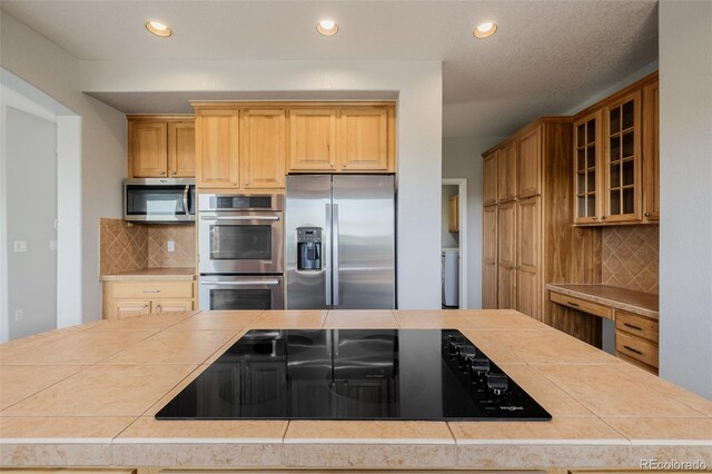 3126 Aspen Creek Dr, Highlands Ranch, CO 80129 - kitchen with stainless steel appliances, tile counters, decorative backsplash, glass insert cabinets, and recessed lighting