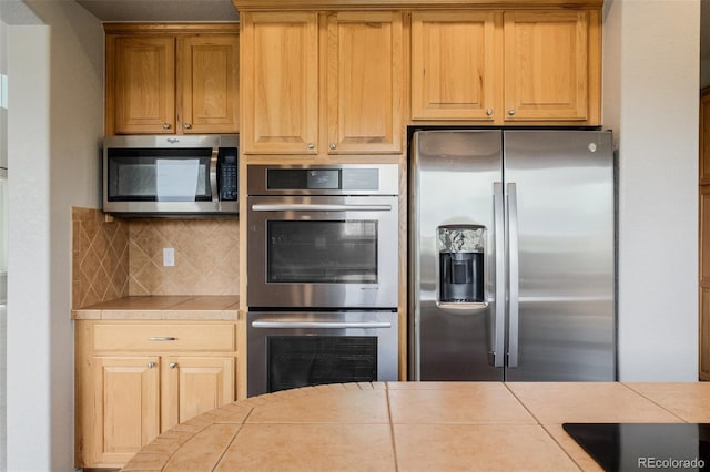 3126 Aspen Creek Dr, Highlands Ranch, CO 80129 - kitchen with appliances with stainless steel finishes, tile countertops, and decorative backsplash