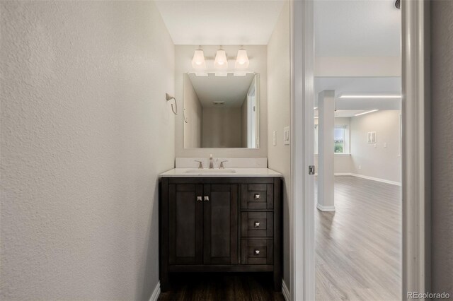 3126 Aspen Creek Dr, Highlands Ranch, CO 80129 - bathroom featuring wood finished floors, vanity, and baseboards