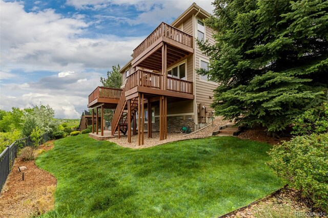 3126 Aspen Creek Dr, Highlands Ranch, CO 80129 - back of property with stairs, a wooden deck, and stone siding