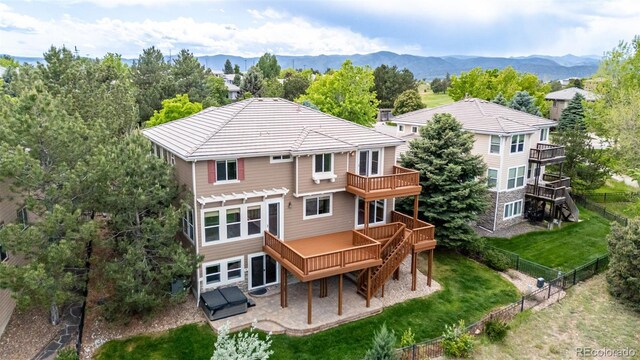 3126 Aspen Creek Dr, Highlands Ranch, CO 80129 - rear view of house with stairway, a deck with mountain view, a patio area, and view of scattered trees