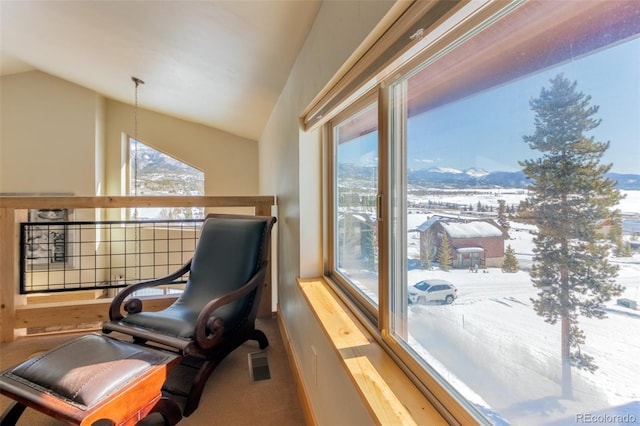 living area featuring lofted ceiling, carpet, visible vents, and a mountain view