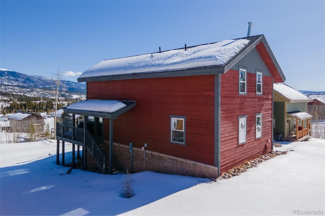 snow covered property with a mountain view