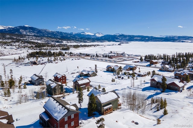 snowy aerial view with a mountain view