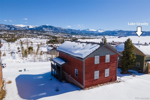 snowy aerial view with a mountain view