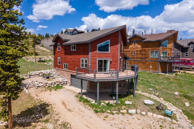 141 Gcr 4037, Grand Lake, CO 80447 - rear view of house with a wooden deck, an attached garage, and driveway