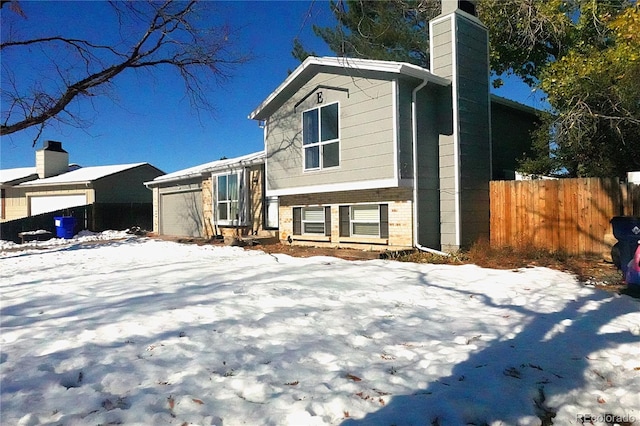 17413 E Louisiana Ave, Aurora, CO 80017 - view of front of house with a chimney, a garage, and brick siding