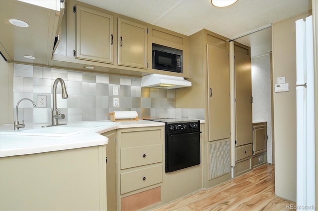 10795 County Road 197a Unit 6, Nathrop, CO 81236 - kitchen with black appliances, custom range hood, light wood-style floors, and decorative backsplash