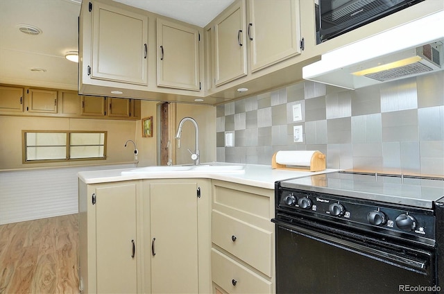 10795 County Road 197a Unit 6, Nathrop, CO 81236 - kitchen featuring black range with electric cooktop, light wood finished floors, light countertops, extractor fan, and backsplash