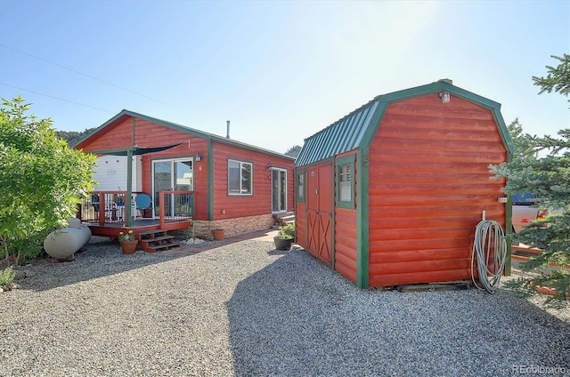 10795 County Road 197a Unit 6, Nathrop, CO 81236 - back of house featuring a gambrel roof, a wooden deck, a metal roof, and a shed