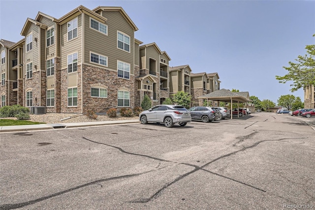 9185 Wilde Ln Unit 301, Parker, CO 80134 - view of property featuring covered and uncovered parking and central AC
