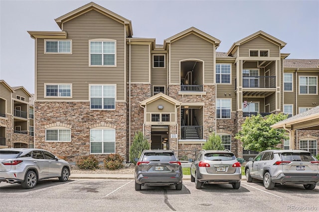 9185 Wilde Ln Unit 301, Parker, CO 80134 - view of front of property featuring uncovered parking and stone siding