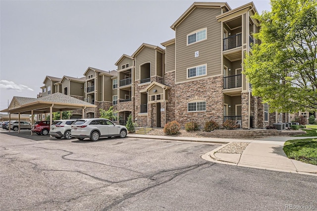 9185 Wilde Ln Unit 301, Parker, CO 80134 - view of property featuring covered and uncovered parking