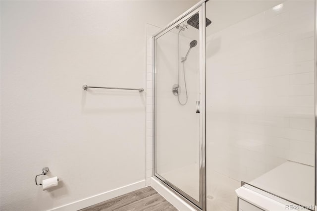 9185 Wilde Ln Unit 301, Parker, CO 80134 - full bathroom with wood finished floors, a stall shower, and baseboards