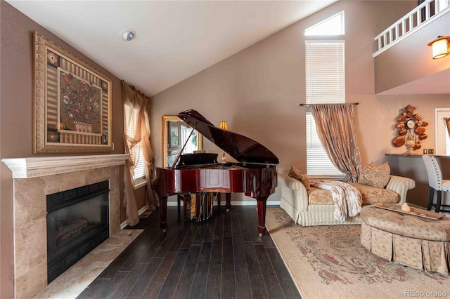 12242 Bannock Cir Unit D, Denver, CO 80234 - living area featuring hardwood / wood-style floors, lofted ceiling, a premium fireplace, and baseboards